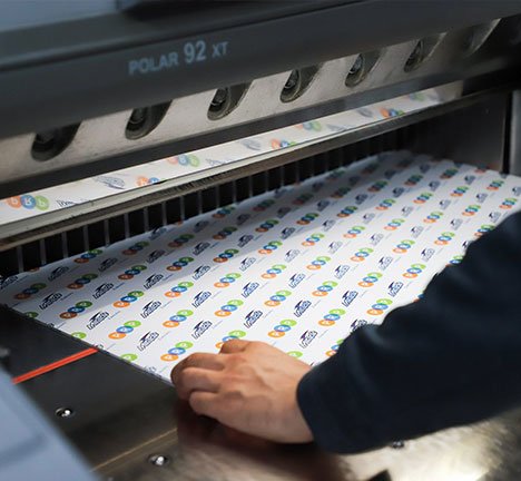 Print shop technician operating machinery